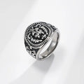Silver ring with intricate design on a light gray background