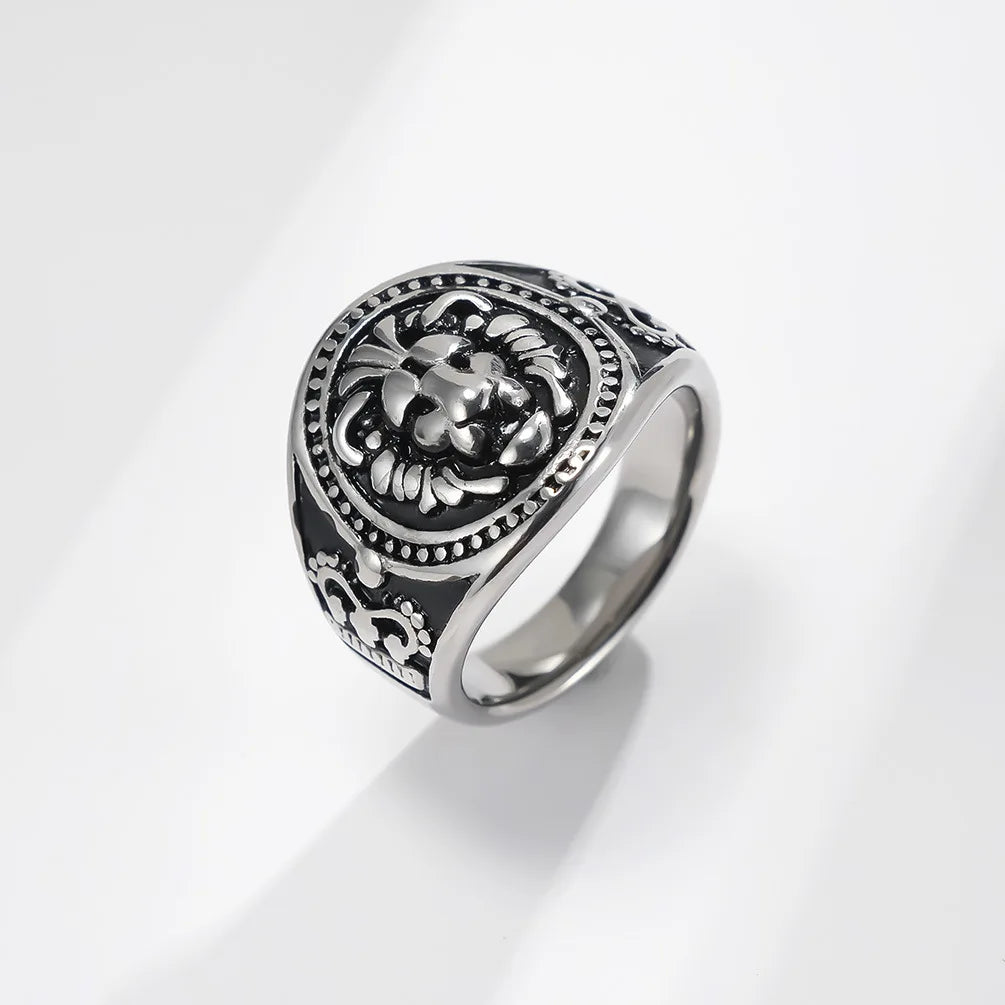 Silver ring with intricate design on a light gray background